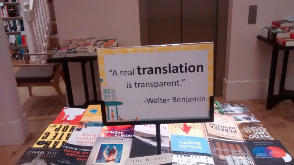 Table of books for sale and a sign with the quote A real translation is transparent -Walter Benjamin